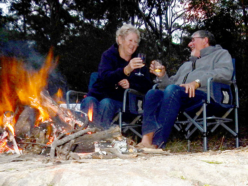 Gordon and Barbara Campbell ejoy a vino round the campfire